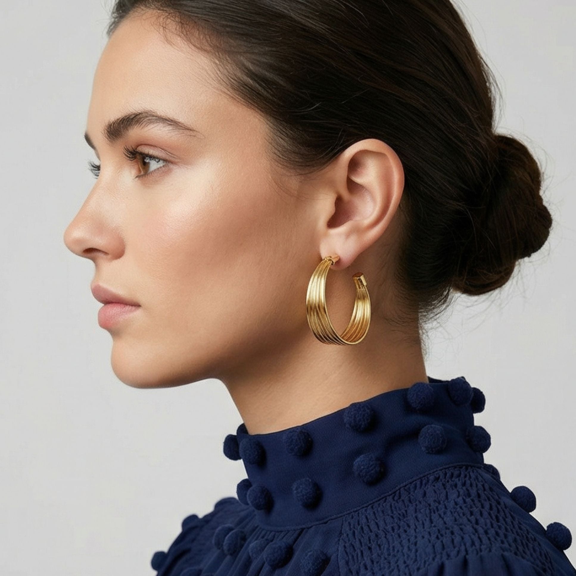 Boucles d’oreilles Lucca en plaqué-or portées, créoles texturées élégantes sur fond clair – Jossepo