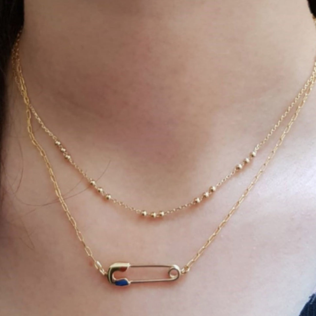 Collier deux rangs doré avec pendentif épingle émaillée en plaqué or 18 carats porté au cou